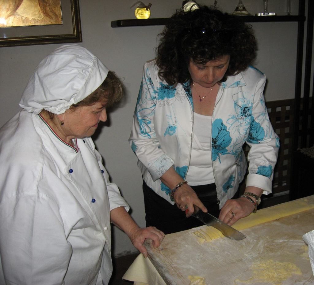 Chef Mirella guiding me on how to cut the strangozzi.