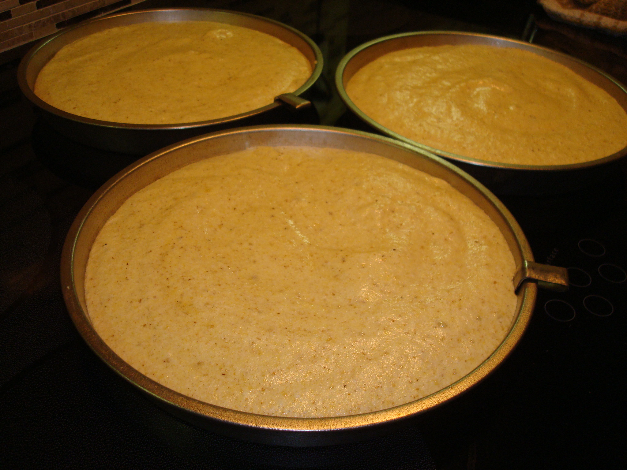 Walnut torta batter divided into three baking pans - My Cookbook Addiction